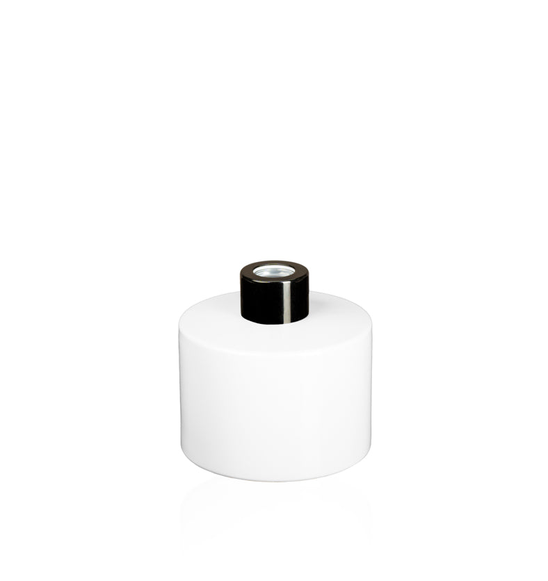 Image of a stout white glass diffuser bottle with a black collar on a white background to represent Village Craft & Candle's Lavish Diffuser Bottle. || Image d'une bouteille de diffuseur en verre blanc trapue avec un col doré sur un fond blanc pour représenter la bouteille de diffuseur Lavish de Village Craft & Candle.