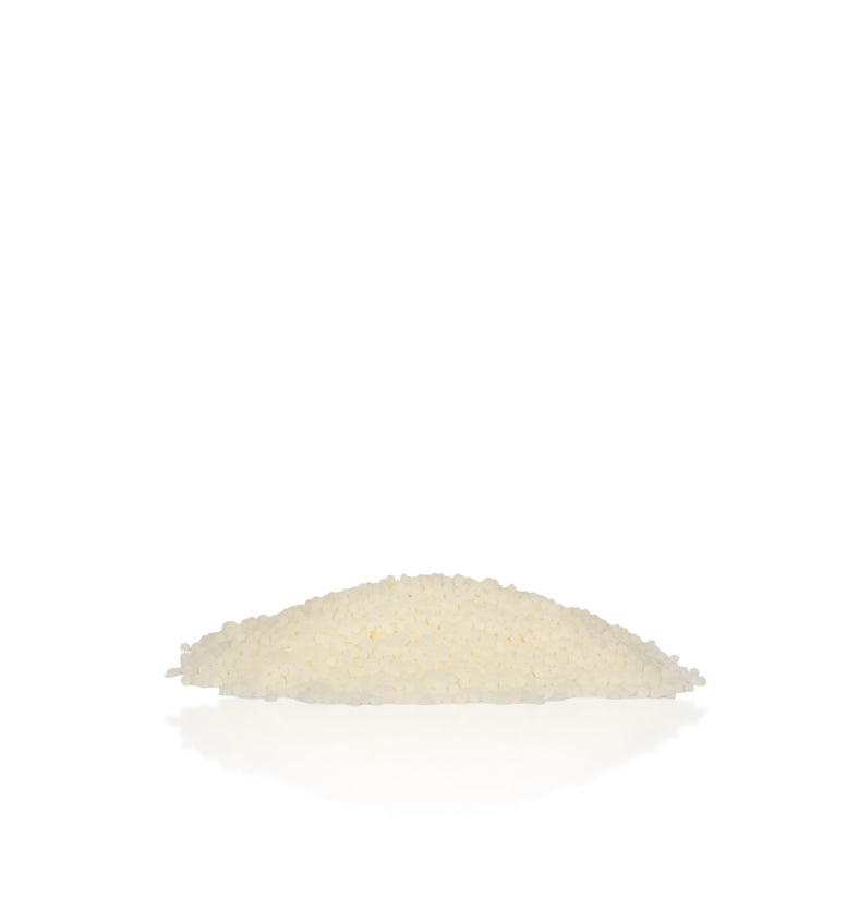 Image of a pile of white wax beads to represent Village Craft & Candles White Beeswax Pastilles. || Image d'un tas de perles de cire blanche pour représenter les pastilles de cire blanche de Village Craft & Candles.