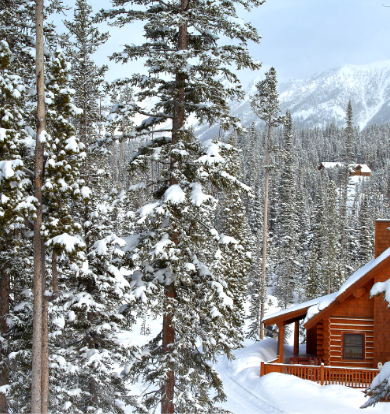 Log cabin in a snowy forest in the mountains as a visual representation of Alpine Getaway Fragrance Oil available at Village Craft and Candle || Cabane en rondins dans une forêt enneigée dans les montagnes comme représentation visuelle de l'huile parfumée Alpine Getaway disponible chez Village Craft and Candle