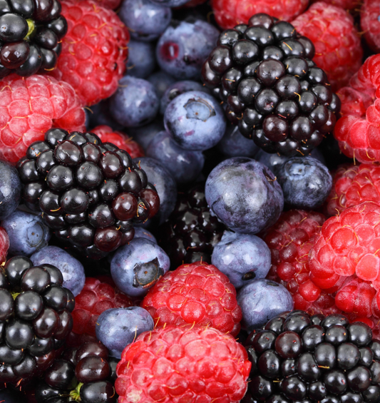 Assorted blueberries, raspberries, blackberries and strawberries with mint garnish as a visual representation of Berry Blaster Fragrance Oil available at Village Craft and Candle