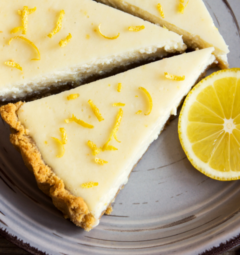 Slice of lemon cheesecake as a visual representation of Lemon Cheesecake Fragrance Oil available at Village Craft and Candle || Tranche de cheesecake au citron comme représentation visuelle de l'huile parfumée Lemon Cheesecake disponible chez Village Craft and Candle