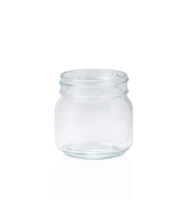 Clear 6 oz Mason glass jar for candles, showing the wide opening and thick base. Unlidded product shot on a white background. || Pot Mason transparent de 6 oz pour bougies, montrant la large ouverture et la base épaisse. Produit sans couvercle présenté sur fond blanc.