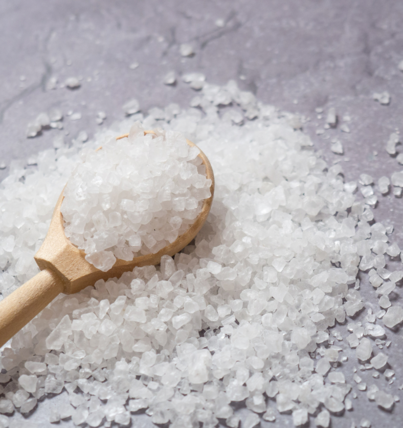 Wooden spoonful of coarse salt as a visual representation of Sea Salt Fragrance Oil available at Village Craft and Candle || Cuillerée en bois de gros sel comme représentation visuelle de l'huile parfumée au sel de mer disponible chez Village Craft and Candle