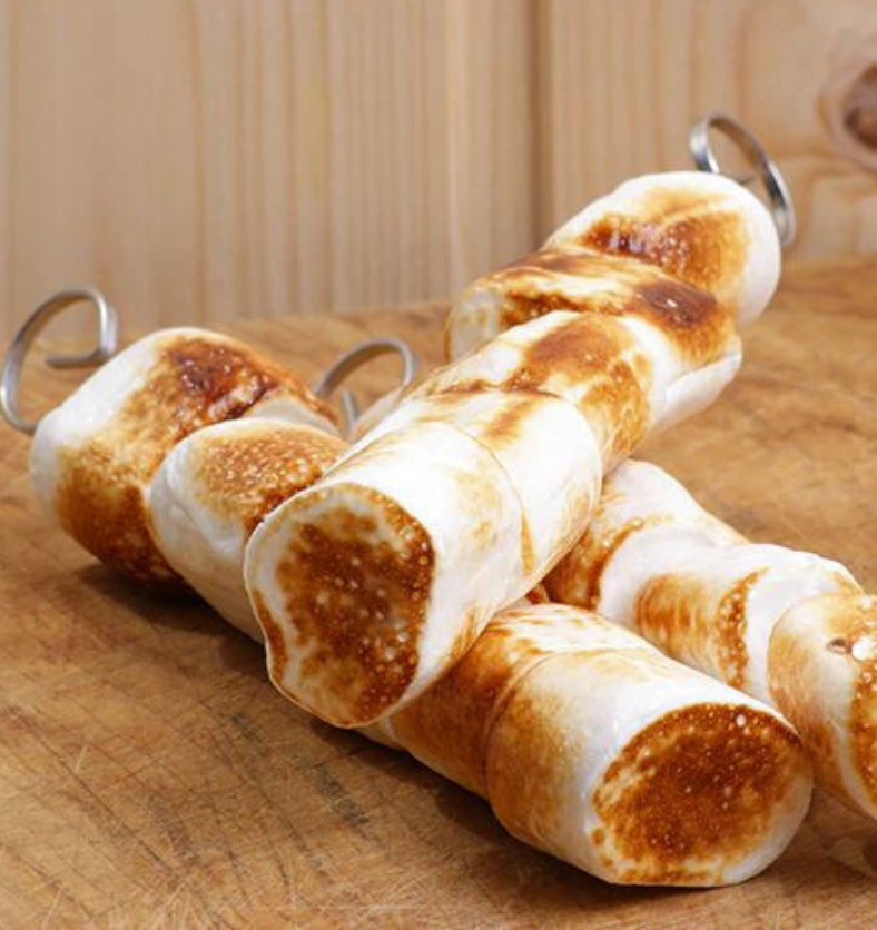3 skewers of toasted marshmallows as a visual representation of Toasted Marshmallow Fragrance Oil available at Village Craft and Candle || 3 brochettes de guimauves grillées comme représentation visuelle de l'huile parfumée de guimauve grillée disponible chez Village Craft and Candle