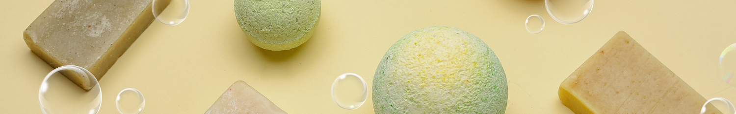 soaps, bathbombs and bubbles on pale yellow background