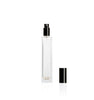 Image of a tall, narrow, clear glass bottle with a black top on a white background to represent Village Craft & Candle's 4oz Charisma Bottle for room sprays. || Image d'une bouteille en verre claire, haute et étroite avec un bouchon noir sur un fond blanc pour représenter la bouteille Charisma de 4oz de Village Craft & Candle pour les vaporisateurs d'ambiance.