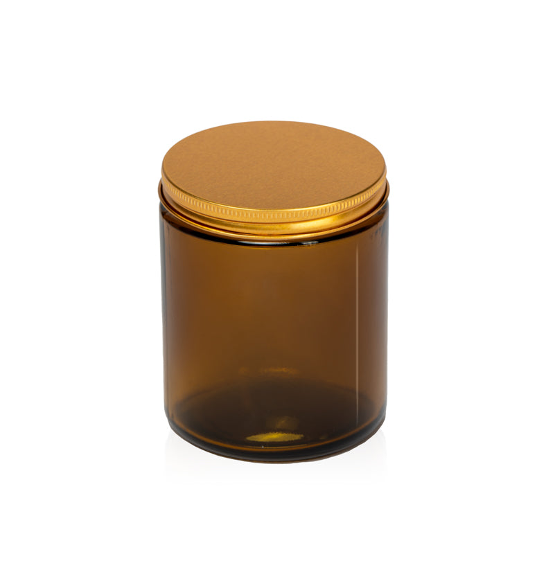 Image of an amber glass jar with a low profile gold lid to represent Village Craft & Candle's 8oz Amber Element Straight Side Jar & Classic Gold Element Lid for candle making || Image d'un pot en verre ambre avec un couvercle doré à profil bas représentant le pot droit Element ambre de 8 oz et le couvercle doré classique Element de Village Craft & Candle pour la fabrication de bougies.