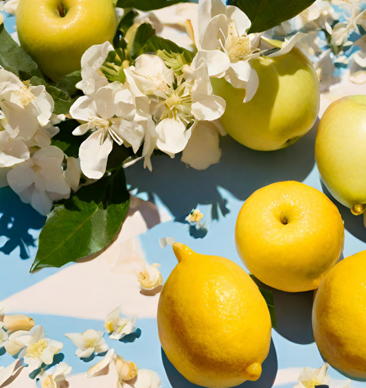 An image of lemons, jasmine petals, & apples to represent  the Village Craft & Candle Blue Sky Fragrance Oil | Une image de citrons, de pétales de jasmin et de pommes pour représenter l'huile de parfum Blue Sky de Village Craft & Candle.