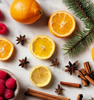 Sliced citrus fruits with assorted spices, cinnamon, berries, and balsalm on white background  as a visual representation of Citrus Balsam Fragrance Oil available at Village Craft and Candle || Agrumes tranchés avec un assortiment d'épices, de cannelle, de baies et de baume sur fond blanc comme représentation visuelle de l'huile parfumée Citrus Balsam disponible chez Village Craft and Candle