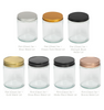 Image of a clear glass jar with all lid options to represent Village Craft & Candle's 8oz Clear Flint Element Straight Side Jar & Element Lids for candle making. || Image d’un pot en verre transparent avec toutes les options de couvercle pour représenter le pot droit Flint Element clair de 8 oz de Village Craft & Candle et les couvercles Element pour la fabrication de bougies.