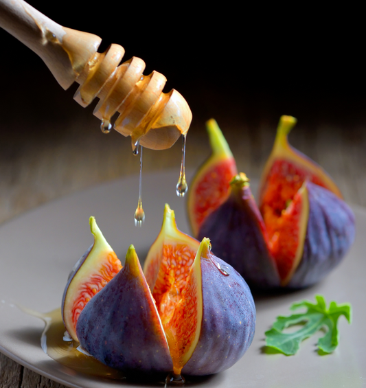 Figs and honey on grey plate as a visual representation of Honey Fig and Ginger Fragrance Oil available at Village Craft and Candle 