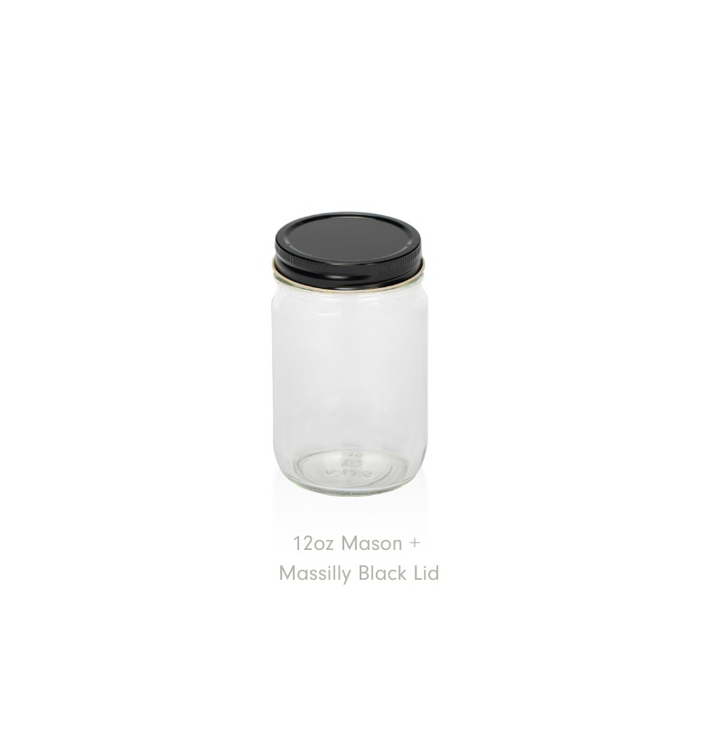 A clear 12oz Mason jar with a black Massilly lid on a white background. || Un pot Mason transparent de 12 oz avec un couvercle noir Massilly sur fond blanc.