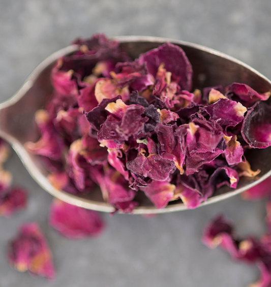 Teaspoon of dried rose petals as a visual representation of Rose Petals Fragrance Oil available at Village Craft and Candle 