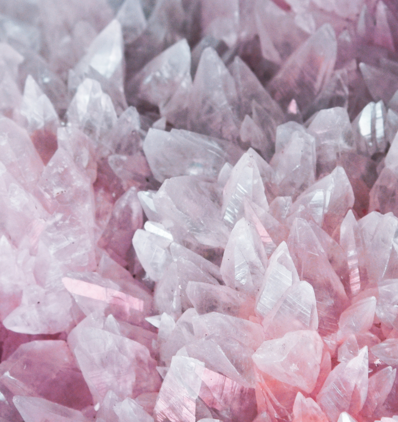 Close up of a field of rose quartz as a visual representation of Rose Quartz Fragrance Oil available at Village Craft and Candle || Gros plan d'un champ de quartz rose comme représentation visuelle de l'huile parfumée de quartz rose disponible chez Village Craft and Candle