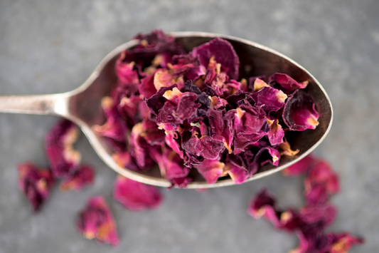 Teaspoon of dried rose petals as a visual representation of Rose Petals Fragrance Oil available at Village Craft and Candle 