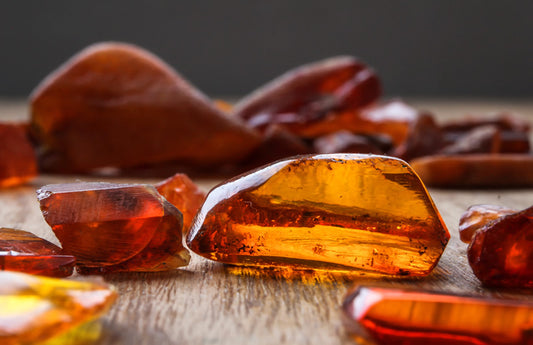 Pièces d'ambre sur une table comme représentation visuelle de l'huile parfumée d'ambre sensuelle disponible chez Village Craft and Candle
